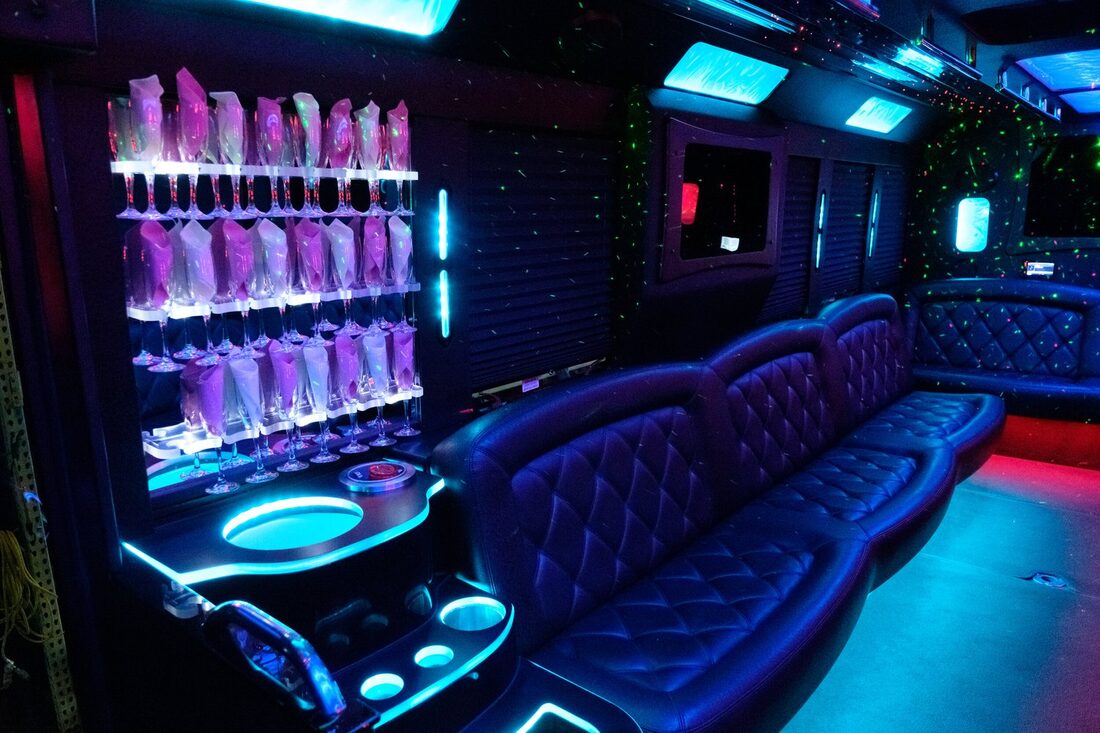 MiniCoach Limo Bus interior, lounge seating and flat screens